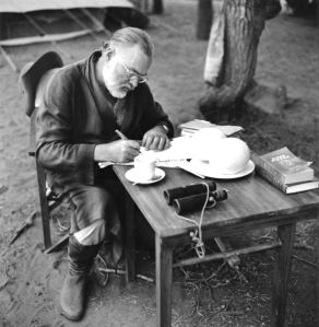 KENYA - SEPTEMBER 1952:  Author Ernest Hemingway writes at a portable table while on a big game hunt in September 1952 in Kenya.  (Photo by Earl Theisen/Getty Images)